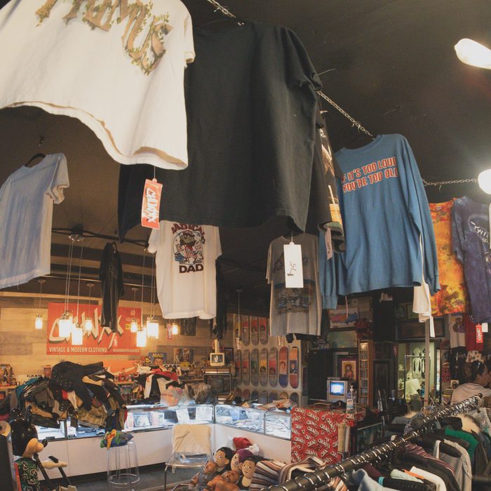 Vintage tees hanging from the ceiling at Chunxx, a Primus shirt up front